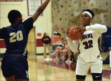  ?? TANIA BARRICKLO- DAILY FREEMAN ?? Kalia Hylton-Jackson of Kingston handles the bar while being guarded by Newburgh’s Ameerah Cotton during Monday’s girls basketball game.