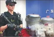  ?? ZHENG CAIXIONG / CHINA DAILY ?? Seized drugs and cooking devices are displayed at the provincial public security department in Guangzhou, Guangdong province, on Tuesday.