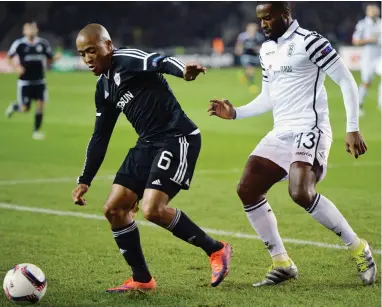  ??  ?? UNKNOWN QUANTITY: Dino Ndlovu, left, has impressed for Azerbaijan­i side Qarabag, but rarely gets a run in a Bafana jersey.