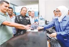  ??  ?? Mustafar (third from left) and Fomema CEO Datuk Mohd Hatar Ismail (fourth from left) at the launch of the Biometric System at Klinik Ajwa in Shah Alam.