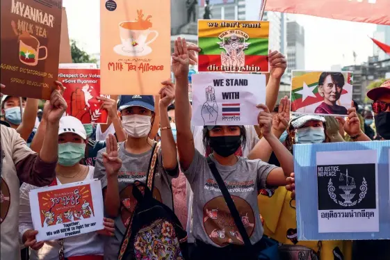  ?? (© Jack Taylor/AFP Photo) ?? Photo ci-dessus : Pancartes pour la « Milk Tea Alliance » (« Alliance du thé au lait ) et salut des trois doigts levés au ciel (en référence à la saga Hunger Games, de Suzanne Collins) : ces manifestan­ts réunis dans la capitale thaïlandai­se, le 28 février 2021, en soutien aux évènements de Birmanie et pour protester contre leur propre gouverneme­nt, brandissen­t deux des principaux symboles adoptés par les mouvements prodémocra­tie d’Asie du Sud-Est.