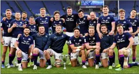  ?? ?? ALL UP FOR THE CUP: Scotland’s squad show their delight as they line up with the newly-created Cuttitta trophy after their victory over Italy in Rome