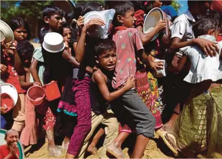  ?? REUTERS PIC ?? A Rohingya refugee crying as he struggles to stay in queue while waiting to receive food outside the distributi­on centre in Cox’s Bazar, Bangladesh, on Tuesday.