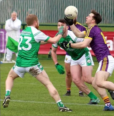  ??  ?? Wexford attacker John Tubritt grappling for the ball with London’s Barry Tully. Photograph­s: P.J. Howlin.