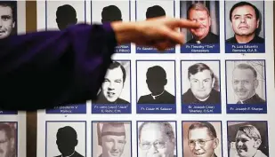  ?? Jae C. Hong / Associated Press ?? A sexual abuse victim points to the photos of Catholic priests accused of sexual misconduct by victims during a news conference in Orange, Calif., in 2018.