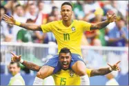  ?? Dan Mullan / Getty Images ?? Brazil’s Neymar, top, celebrates with teammate Paulinho after scoring his team’s first goal during Monday’s World Cup match against Mexico in Samara, Russia.