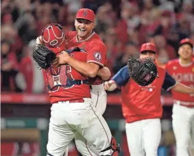  ?? KIRBY LEE/USA TODAY SPORTS ?? Reid Detmers celebrates with catcher Chad Wallach after throwing a no-hitter for the Angels on Tuesday night against the Rays.