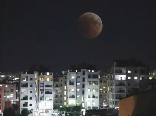  ?? (Photos: Reuters) ?? THE MOON is seen during a lunar eclipse over Idlib, Syria, on July 27.