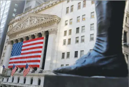  ?? AGENCIES ?? The boot on the statue of George Washington, the first president of the United States, is seen from across the New York Stock Exchange following Election Day in Manhattan, New York City, on Nov 4.