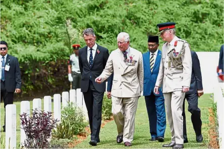  ?? — Bernama ?? An ode to history: Charles visiting the Commonweal­th War Graves Commission in Taiping. Also present is Perak Mentri Besar Datuk Seri Dr Zambry Abdul Kadir.