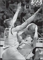  ?? AP/SUE OGROCKI ?? Oklahoma State’s Mitchell Solomon (41) defends a shot by Texas Tech’s Zhaire Smith during Wednesday night’s game at Stillwater, Okla.