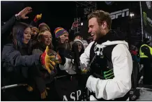  ?? (AP/The Aspen Times/Kelsey Brunner) ?? Gus Kenworthy (right) greets friends and fans at the base of the superpipe at the Winter X Games in Aspen, Colo., last month. Kenworthy is among the few Olympians who were willing to speak out about China’s troubling human rights record leading up to the Olympics.