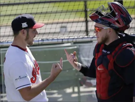  ?? TONY DEJAK — THE ASSOCIATED PRESS ?? Indians starting pitcher Trevor Bauer and catcher Roberto Perez go over signals during a team workout on Oct. 3 in Cleveland.