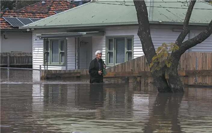  ?? Asanka Ratnayake / Getty Images ?? A resident outside their flood-hit home in the Melbourne suburb of Maribyrnon­g earlier this month.