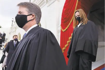  ?? Jonathan Ernst / Getty Images ?? Supreme Court Justices Brett Kavanaugh (left) and Amy Coney Barrett attend the inaugurati­on of President Biden.