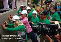  ??  ?? MEROBOHKAN dinding sebagai gimik perasmian.