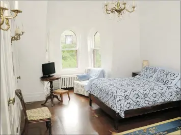  ??  ?? One of several bedrooms, with many heritage features and a television looking a little out of place.