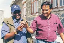  ?? | Picture supplied ?? EBRAHIM Ebrahim, right, receives the master key to his prison cell on Robben Island.