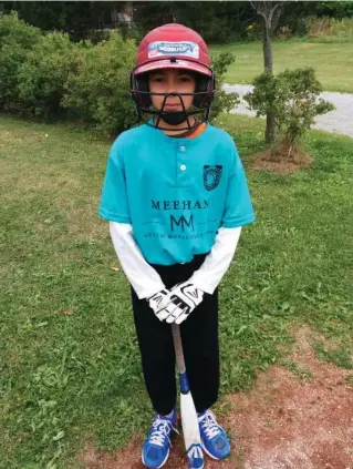  ?? UZMA JALALUDDIN ?? Mustafa Merchant, in his full softball gear, is ready before the championsh­ip game. Uzma Jalaluddin’s sons had never before played softball, not even during gym. But now they love the game.