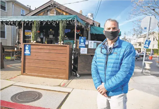  ?? PAULW. GILLESPIE/CAPITAL GAZETTE PHOTOS ?? Kevin Colbeck, owner of Davis’ Pub in Eastport, stands in front of his establishm­ent Dec. 3. Colbeck says he knows the bar will eventually succumb to flooding as sea levels rise.