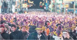  ?? CRAIG RUTTLE THE ASSOCIATED PRESS FILE PHOTOS ?? Revellers in New York gather in Times Square for New Year’s Eve in 2016.