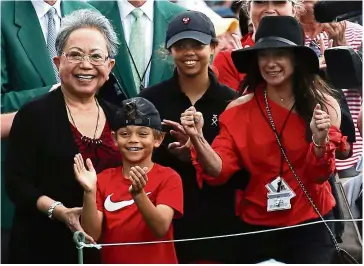  ??  ?? Dad’s a winner again: Tiger Woods’ family (from left) mother Kultida, son Charlie Axel, daughter Sam Alexis and girlfriend Erica Herman, celebrate his US Masters victory on Sunday. — Reuters