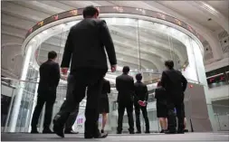  ??  ?? Visitors watch stock prices at the Tokyo Stock Exchange. The Nikkei 225 closed up 0.5% to 22,694.66 points yesterday.