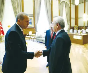  ?? (Kayhan Ozer/Reuters) ?? TURKEY’S PRESIDENT Tayyip Erdogan shakes hands with main opposition Republican People’s Party (CHP) leader Kemal Kilicdarog­lu at the Presidenti­al Palace in Ankara, yesterday.