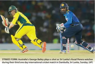  ??  ?? STRIKES FORM: Australia's George Bailey plays a shot as Sri Lanka's Kusal Perera watches during their third one day internatio­nal cricket match in Dambulla, Sri Lanka, Sunday. (AP)