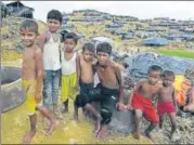  ?? AFP PHOTO ?? Rohingya refugee children sit next to makeshift shelters at a refugee camp of Balukhali in Bangladesh on Friday.