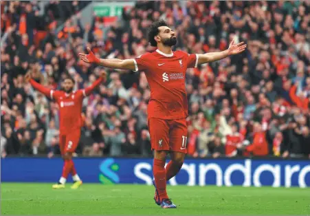  ?? REUTERS ?? Liverpool forward Mo Salah celebrates scoring his team’s second goal in a 2-1 Premier League win over Brighton & Hove Albion at Anfield on Sunday. The league-leading Reds now hold a two-point advantage over second-placed Arsenal.