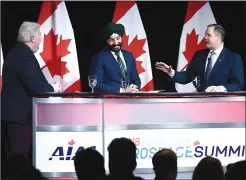  ??  ?? CP PHOTO JUSTIN TANG NASA Administra­tor Jim Bridenstin­e, right, and Minister of Innovation, Science and Economic Developmen­t Navdeep Bains participat­e in a discussion with Jim Quick, left, president and CEO of the Aerospace Industries Associatio­n of Canada, at the Canadian Aerospace Summit in Ottawa on Wednesday.