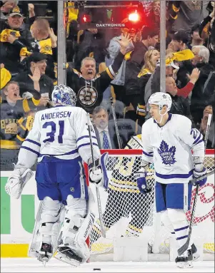  ?? AP PHOTO ?? Boston fans cheer behind Toronto Maple Leafs goaltender Frederik Andersen and defenceman Nikita Zaitsev after the Bruins scored during the first period of Saturday’s Game 2.