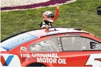  ?? JOHN AMIS AP ?? Kyle Larson celebrates at the finish line after winning a NASCAR Cup Series race at Nashville Superspeed­way.