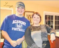  ?? NIKKI SULLIVAN / CAPE BRETON POST ?? Riley Mackie, 15, stands beside his mom, Suzie, in the kitchen of their Gardiner Mines home. Before playing football, Riley was withdrawn and shy, a constant target of bullying. Now he is confident, happy and hopes his story will help others who are...