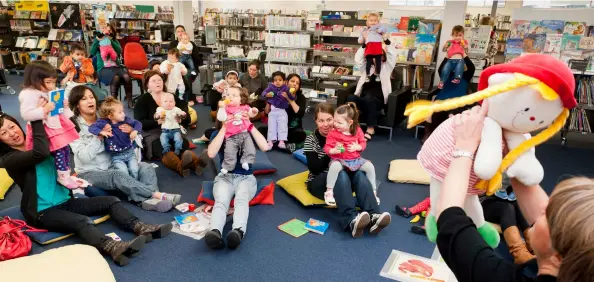  ??  ?? Baby Rock & Rhyme session at Johnsonvil­le Library featuring librarian Debbie Birse