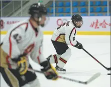  ??  ?? Team member Yang Qing (right) practices controllin­g a puck during a training session on Jan 30.