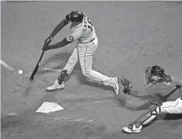  ?? CHARLES KRUPA/AP ?? The Astros’ Jason Castro, left, hits an RBI-single against the Red Sox during the ninth inning in Game 4 of the American League Championsh­ip Series Tuesday in Boston.