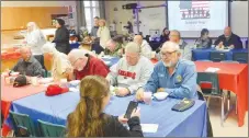  ?? Westside Eagle Observer/SUSAN HOLLAND ?? Service veterans, school board members, administra­tors, Key Club members and guests enjoy a luncheon following the Veterans Day assembly Friday morning, Nov. 11, at Gravette High School. The luncheon, prepared by the high school culinary arts students, featured loaded baked potato soup, salad, rolls, dessert and drinks.