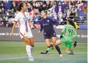  ?? TED S. WARREN AP ?? Wave forward Alex Morgan (center) reacts after she scored a goal against the OL Reign in April.