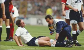  ?? ?? Tottenham’s Paul Gascoigne is treated on the pitch after badly injuring a knee in a reckless tackle on Nottingham Forest’s Gary Charles during the 1991 FA Cup final. Photograph: Getty Images