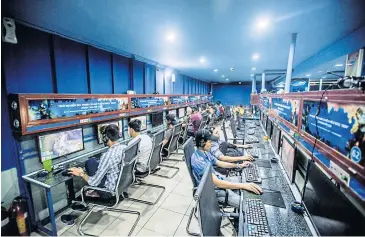  ?? NYT ?? Customers play video games at a cyber cafe in Ho Chi Minh City, Vietnam. A rule set to take effect on Thursday will require some online game providers to have payment systems.
