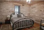  ?? Jerry Lara / Staff photograph­er ?? The master bedroom is surrounded by the original limestone walls of the home, which was built in 1882.