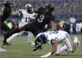  ?? MATT SLOCUM - THE ASSOCIATED PRESS ?? Army’s Jordan Asberry, left, is tackled by Navy’s Sean Williams during the first half of an NCAA college football game, Saturday, Dec. 8, 2018, in Philadelph­ia.