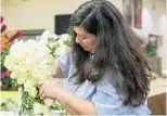  ??  ?? Lynn Privett carefully crafts a bride’s bouquet for an upcoming wedding at Walt Disney World.