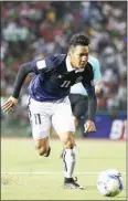  ?? SRENG MENG SRUN ?? Cambodian striker Chan Vathanaka chases down the ball against Afghanista­n yesterday at the Olympic Stadium.
