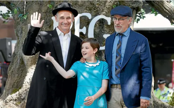  ??  ?? Steven Spielberg, right, poses for photos with actors Mark Rylance and Ruby Barnhill at the British premiere of The BFG in London’s Leicester Square.