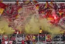  ?? Christof Köpsel/Getty Images ?? Union Berlin fans wave flags and set off smoke bombs in the stands. Photograph: