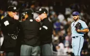  ?? Frank Franklin II / Associated Press ?? Toronto Blue Jays relief pitcher Yimi Garcia watches as home plate umpire Lance Barrett, left, talks with other upmires after Garcia hit New York Yankees’ Josh Donaldson with a pitch during the sixth inning on Tuesday in New York.