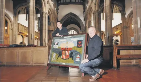  ??  ?? Sunderland Fans’ Museum’s Michael Ganley, right, and the Rev Andrew Dowsett, with the dried flower artwork in memory of Wearmouth Colliery miners.